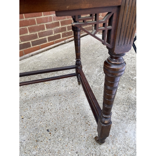 41 - Regency style leather topped desk with brass balustrade to the top drawers, on castors, W107cm xD 56... 