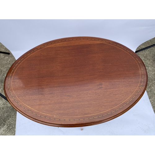 45 - Mahogany oval table with inlaid detailing, H 66cm x D45cm x H74cm