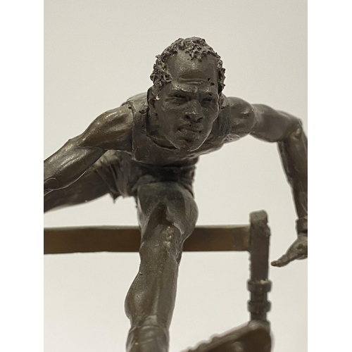 75 - A Bronze hand sculpture of an Olympic hurdler on wooden swivel base, approx. overall height 15cm