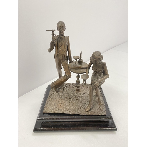 76 - A bronze hand sculpture of 1920s party scene on wooden base, approx. overall max height 20cm