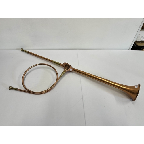 78 - A brass and copper hunting horn alongside another copper and brass hunting / coaching horn approx. o... 