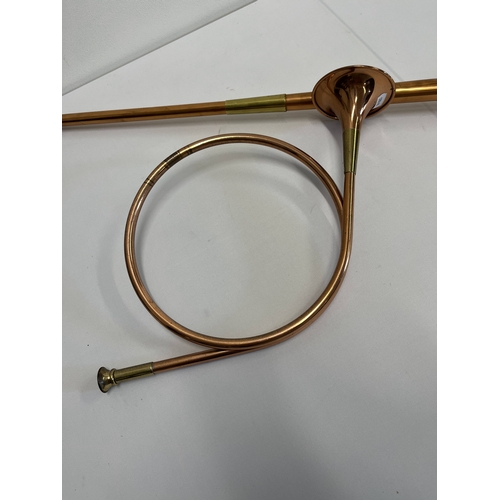 78 - A brass and copper hunting horn alongside another copper and brass hunting / coaching horn approx. o... 