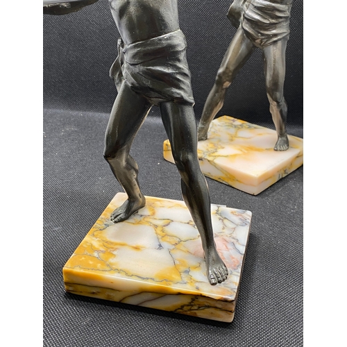 84 - Two bronzed warrior figures on marble plinths