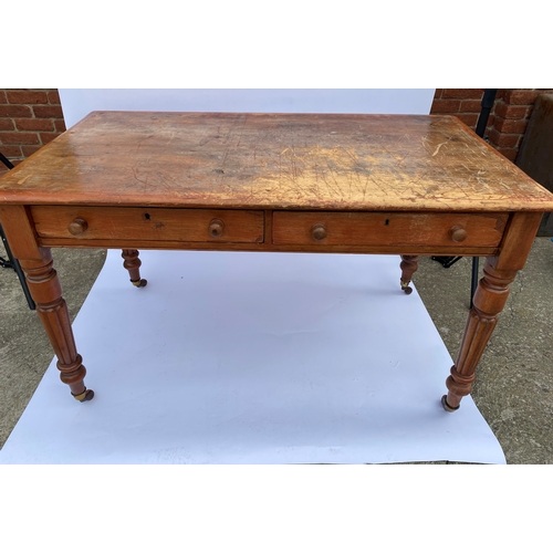 113 - Antique pine side table with two drawers, on castors A/F