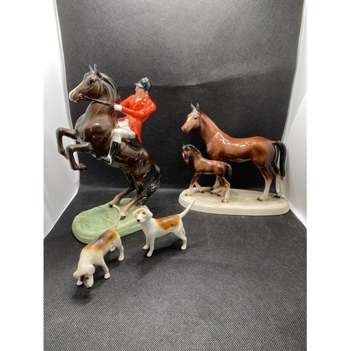 270 - Beswick huntsman on horse in rearing stance with hounds and one other horse and foal ceramic figure ... 