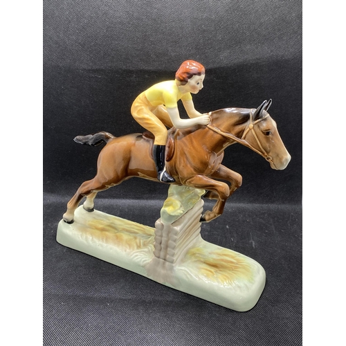 271 -  Beswick hand painted ceramic model of a lady jockey in yellow shirt jumping a fence, makers mark to... 