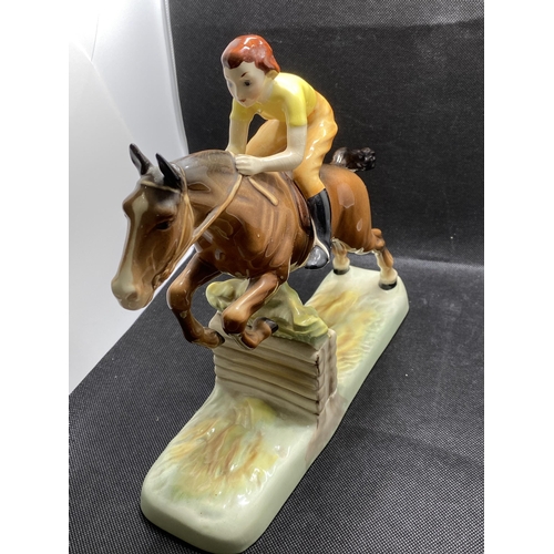 271 -  Beswick hand painted ceramic model of a lady jockey in yellow shirt jumping a fence, makers mark to... 