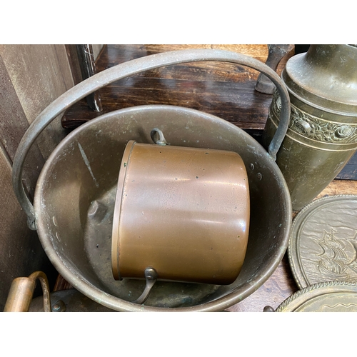 71 - An assortment of brass and copperware items to include chargers, kettles, buckets, jam pan etc.