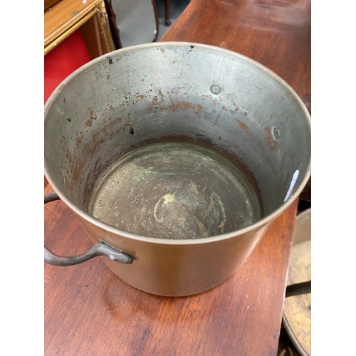 71 - An assortment of brass and copperware items to include chargers, kettles, buckets, jam pan etc.