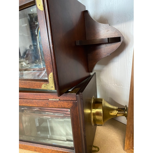 55 - A pair of wall hung mahogany cases with bevelled glass panels and removable brass coloured candle ho... 