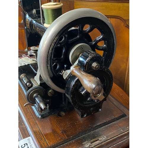 57 - A PFAFF antique sewing machine in black with gold trim serial number 164134 complete with wooden box... 