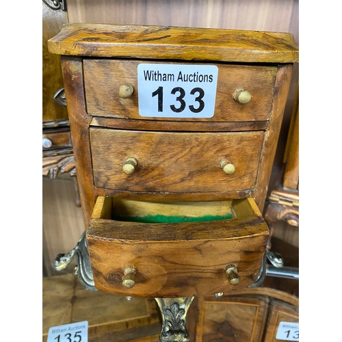 133 - A handcrafted wooden miniature oval chest of drawers with a metal base