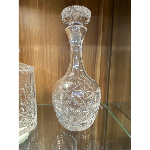 145 - A group of cut glass decanters in different sizes, cuts and styles together with a plateware tray