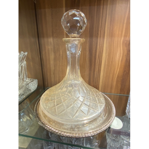 145 - A group of cut glass decanters in different sizes, cuts and styles together with a plateware tray