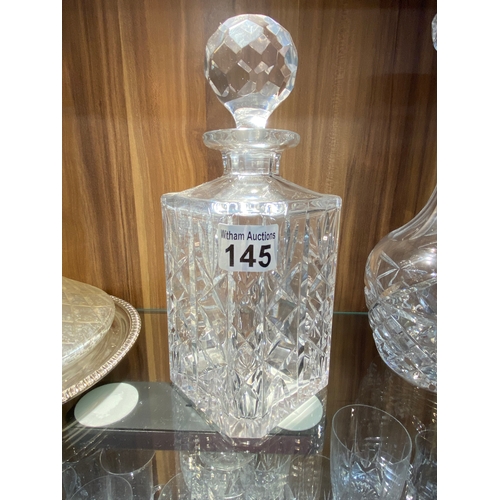 145 - A group of cut glass decanters in different sizes, cuts and styles together with a plateware tray