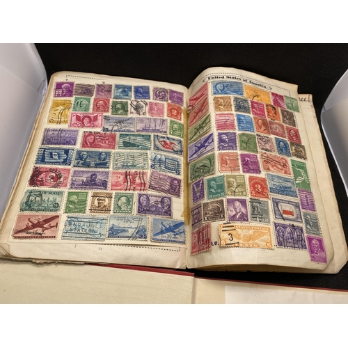 157 - The Globe stamp album, containing stamps from around the world together with a Strand stamp album to... 