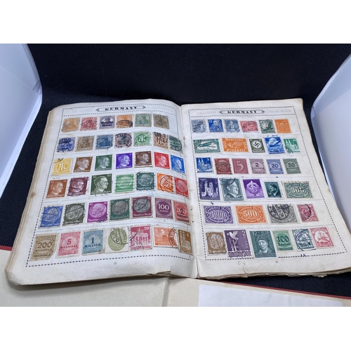 157 - The Globe stamp album, containing stamps from around the world together with a Strand stamp album to... 