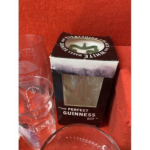 39 - Guinness memorabilia items to include a ceramic Toucan jug, postcards, pint glasses, a Gilroy and Ru... 