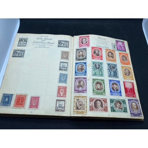 155 - A hardback - The Nelson stamp album, in excess of 135 pages full/part filled with stamps from variou... 