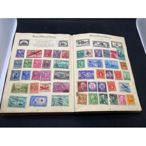 155 - A hardback - The Nelson stamp album, in excess of 135 pages full/part filled with stamps from variou... 