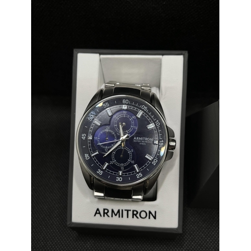 52 - An Armitron men's silver and navy-blue wristwatch, as new with box, with proof of purchase