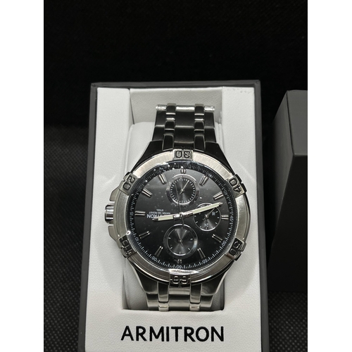 53 - An Armitron gent's silver and black wristwatch, as new with box,  with proof of purchase