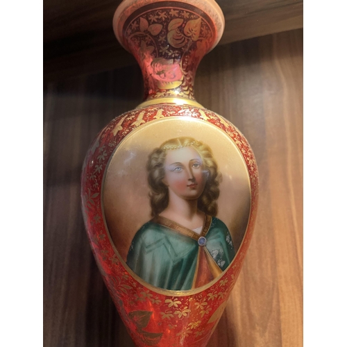 103 - Cranberry vase with hand painted portrait and gold gilt design of flowers, approx height 30cm