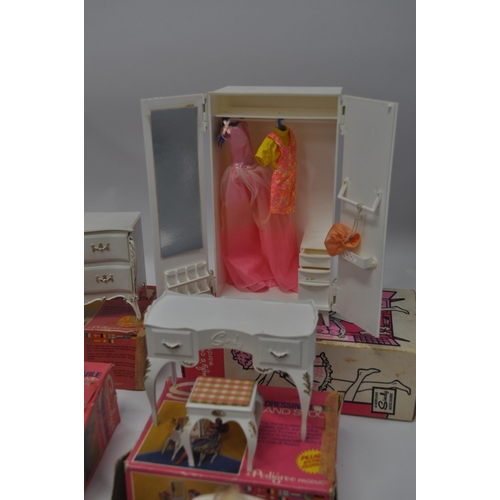 174 - A selection of Sindy furniture items, predominantly boxed items to include; sideboard, bed and bedcl... 