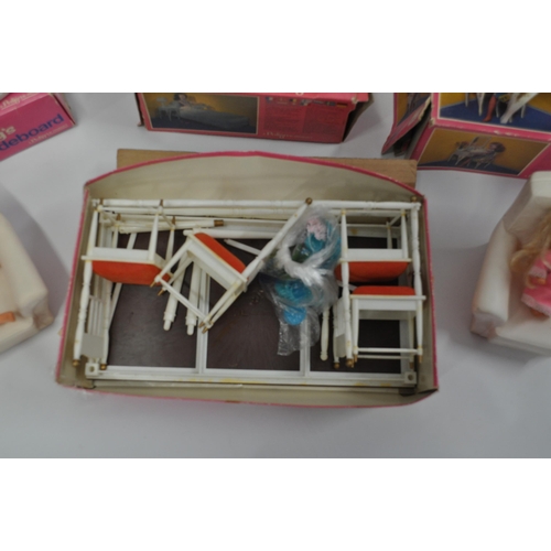 174 - A selection of Sindy furniture items, predominantly boxed items to include; sideboard, bed and bedcl... 