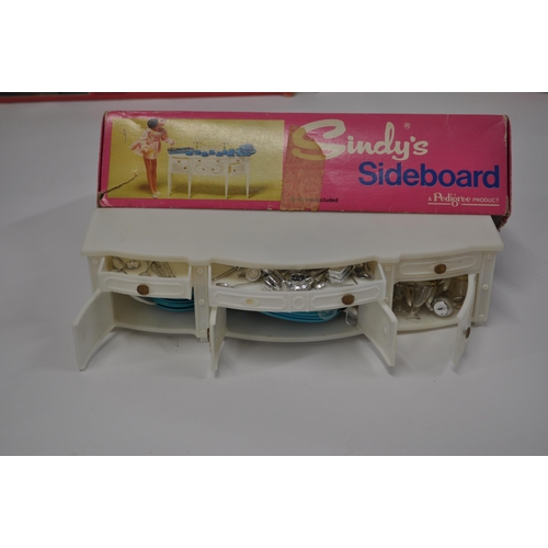 174 - A selection of Sindy furniture items, predominantly boxed items to include; sideboard, bed and bedcl... 