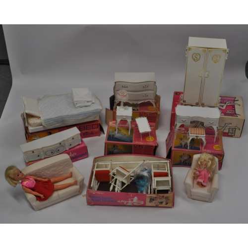 174 - A selection of Sindy furniture items, predominantly boxed items to include; sideboard, bed and bedcl... 