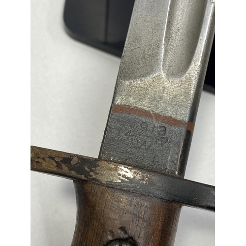 215 - A 1913 pattern bayonet, with stamps, with 43cm fullered blade and scabbard with wooden handle