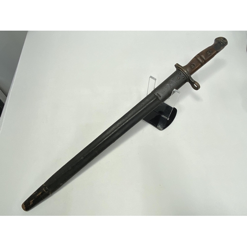 215 - A 1913 pattern bayonet, with stamps, with 43cm fullered blade and scabbard with wooden handle