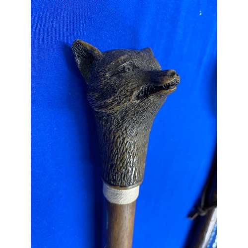 149 - Nailsea glass walking cane with four other walking sticks, one with a fox head