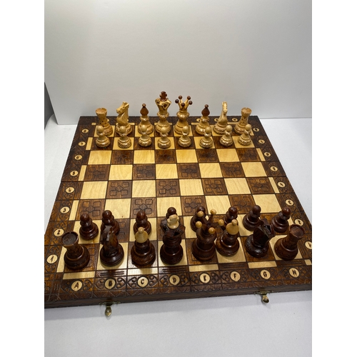 143 - Two chess sets, one hand carved senator chess set and one mini wooden travelling chess set in foldin... 