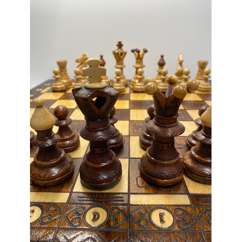 143 - Two chess sets, one hand carved senator chess set and one mini wooden travelling chess set in foldin... 