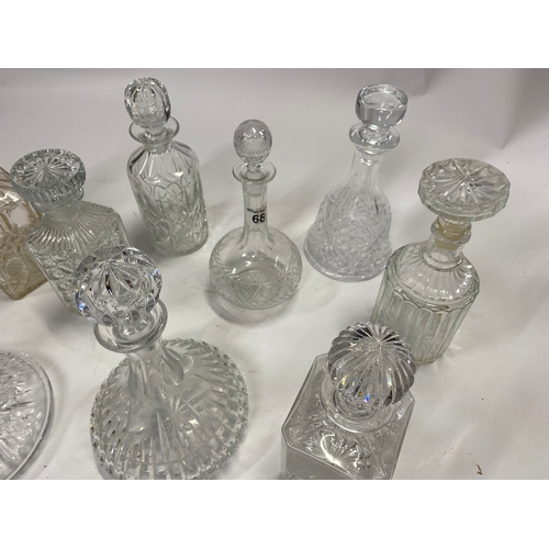 68 - A quantity of glass decanters in various styles including ships decanters, x9