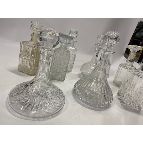 68 - A quantity of glass decanters in various styles including ships decanters, x9