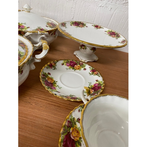 105 - A selection of country roses tureens and soup bowls with small plates and saucers.