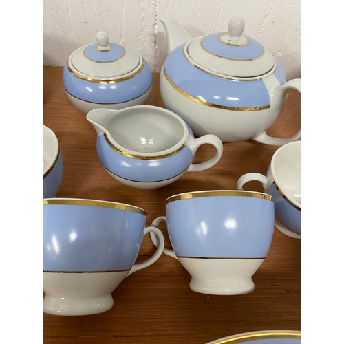 123 - A Royal Doulton 2004 Bruce Oldfield 8 setting dinner set with two tureens, two serving bowls, and te... 