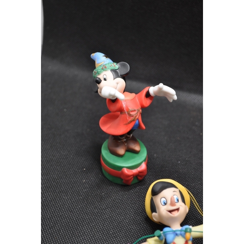 42 - A group of 4 hanging Christmas tree ornaments to include Fantasia Mickey, 2003, Ariel from The Littl... 