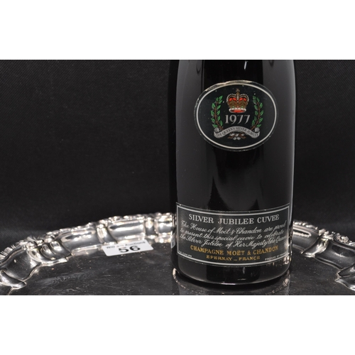 56 - A bottle of Moet & Chandon, 1977 silver Jubilee Cuvee together with a silver coloured decorative tra... 