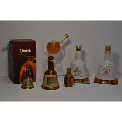 63 - A collection of different bottles of whisky's including Stylish Whisky globe bottle, bells and a bot... 