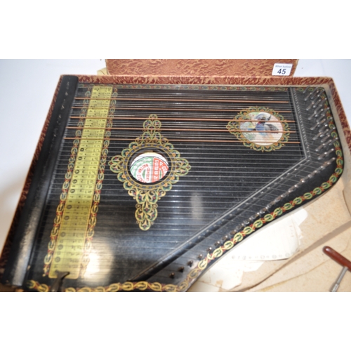 45 - A 6 chord concert guitar-zither with a bird design and other border decoration beneath strings, toge... 