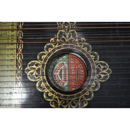 45 - A 6 chord concert guitar-zither with a bird design and other border decoration beneath strings, toge... 