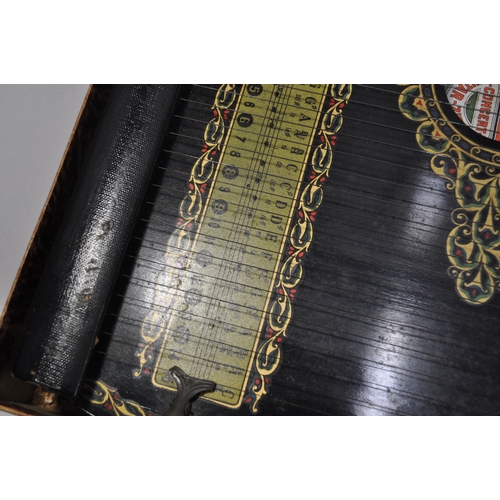 45 - A 6 chord concert guitar-zither with a bird design and other border decoration beneath strings, toge... 