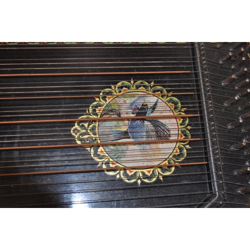 45 - A 6 chord concert guitar-zither with a bird design and other border decoration beneath strings, toge... 