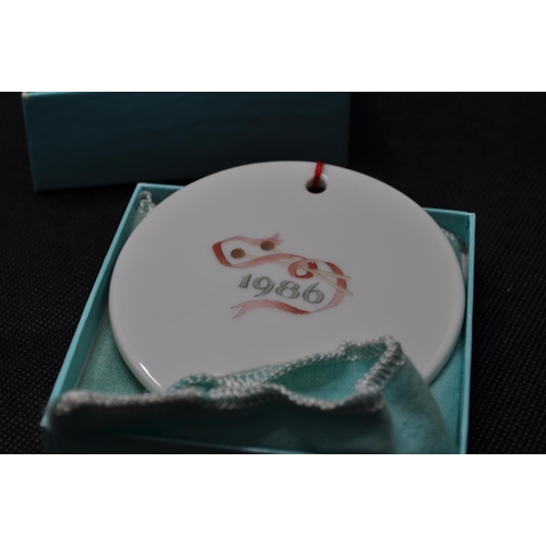 41 - x4 Tiffany & Co hanging decorations; x 3 bone china discs with traditional festive designs dated 198... 