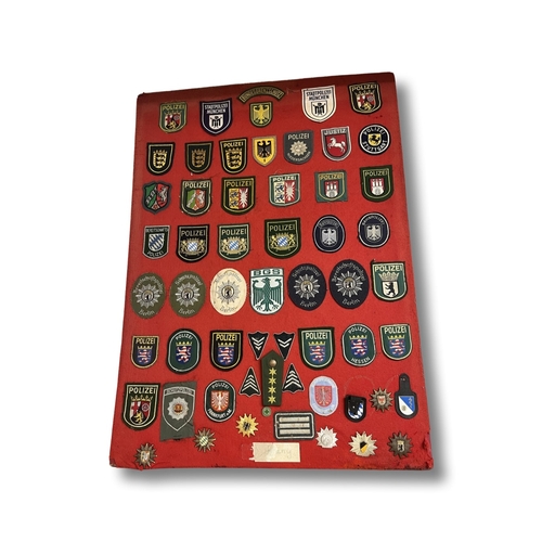 229 - A collection of police items to include a Essex Police hat plus one other, framed and unframed badge... 