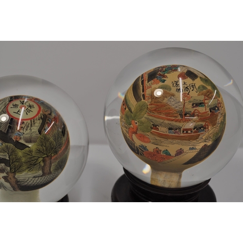 22 - Two vintage oriental reverse hand painted glass sphere/globe on stands, with signatures, approx diam... 